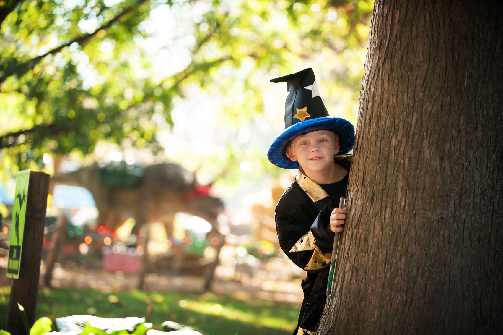 Child hiding behind tree